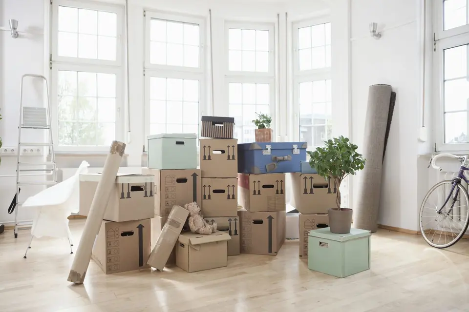 Packed moving boxes prepared in a bright home
